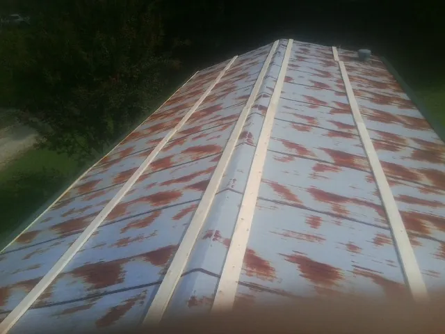 Rusted metal roof panels with new wood purlins before replacement — Storm Damage Roof Repair in Inglewood by Roofing Brothers